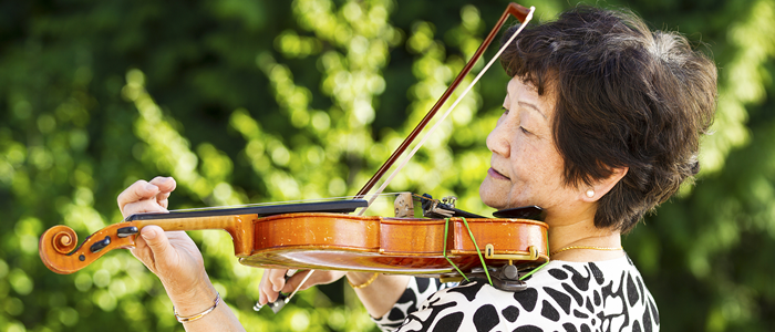 Elderly woman playing violin