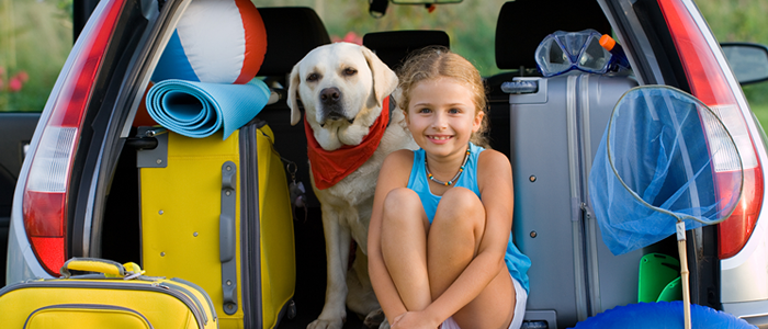 Girl and dog in back of car